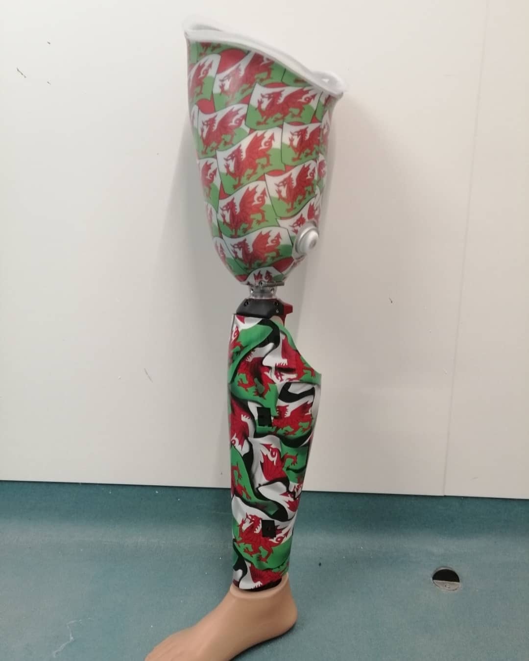 Prosthetic leg shown with welsh flag design with red dragons